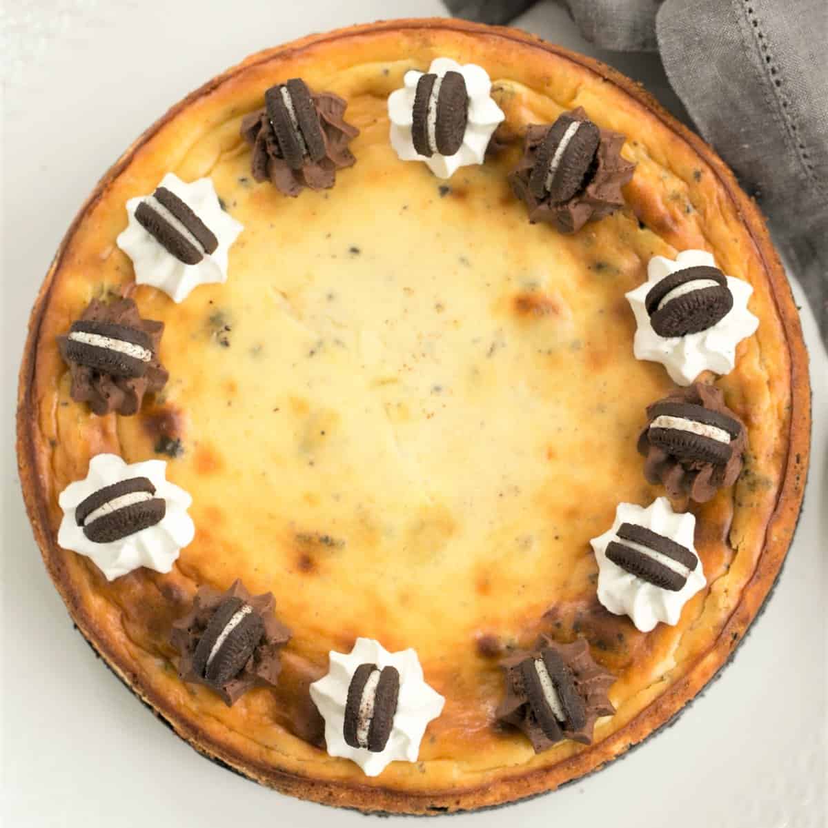 Oreo Cheesecake with Oreo Cookie Crust - a double dose of Oreos in this incredibly rich, delicious dessert Overhead view of Oreo Cheesecake with Oreo Cookie Crust on a serving plate.