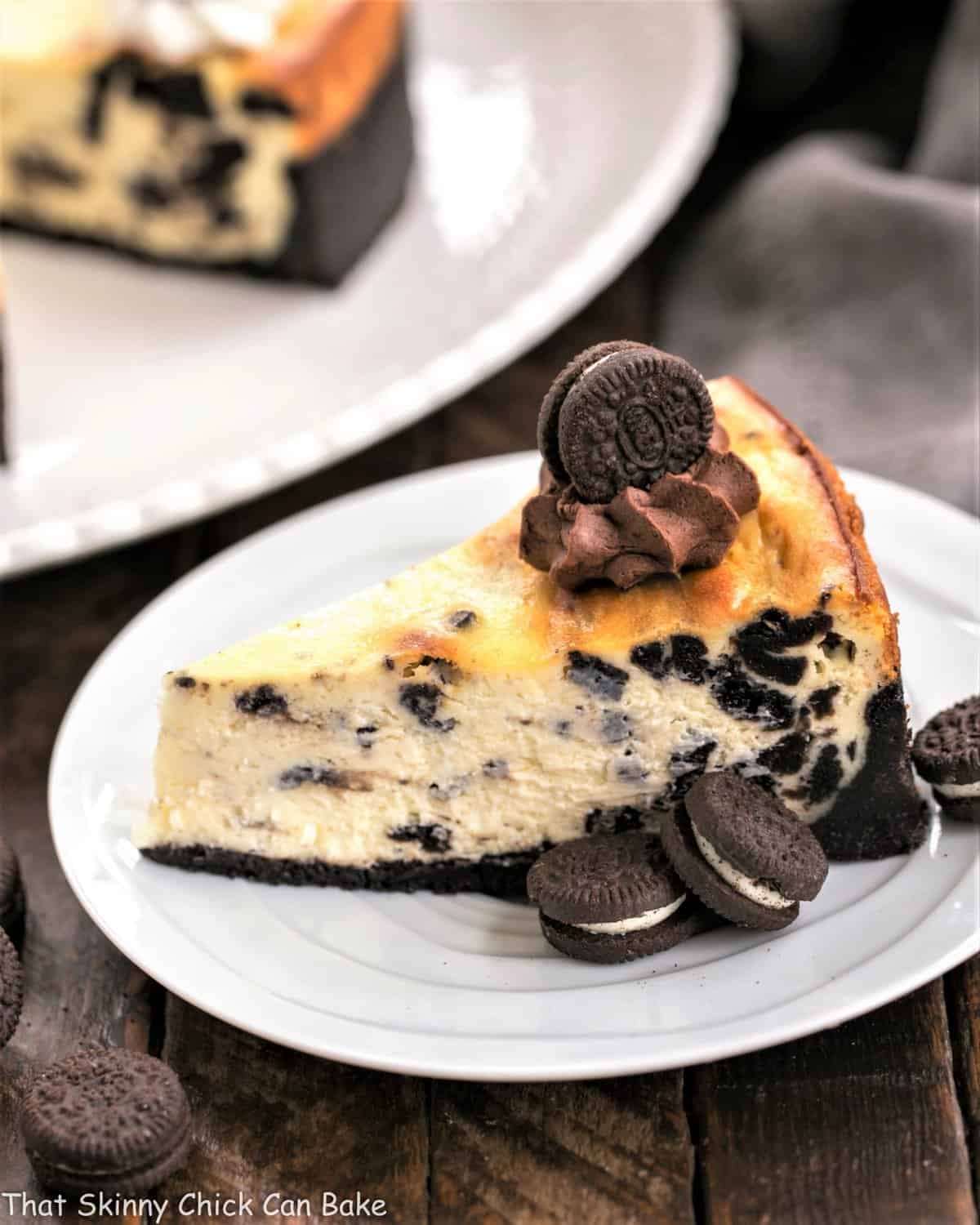 Oreo Cheesecake with Oreo Cookie Crust - a double dose of Oreos in this incredibly rich, delicious dessert Slice of Oreo Cheesecake with Oreo Cookie Crust on a white plate.
