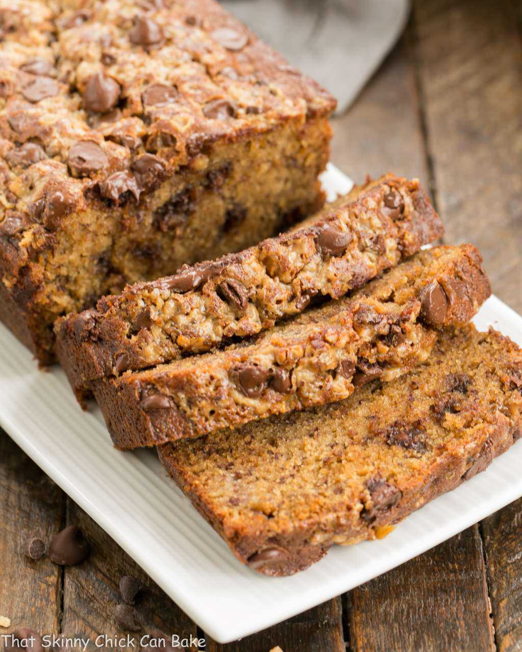 Chocolate Chip Toffee Banana Bread sliced on a white platter.