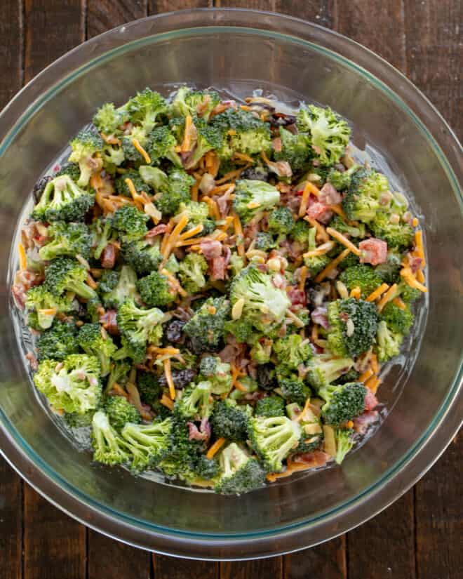Overhead view of salad ingredients mixed with dressing.