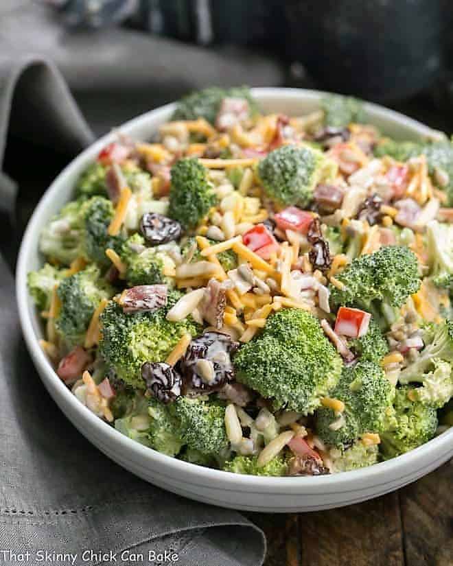 Broccoli Salad with Bacon and Dried Cherries - Perfect for picnics and potlucks! White ceramic bowl filled with Broccoli Salad with Bacon and Dried Cherries.