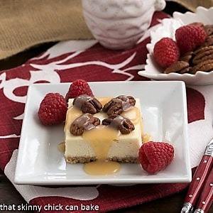 A slice of caramel pecan cheesecake bars