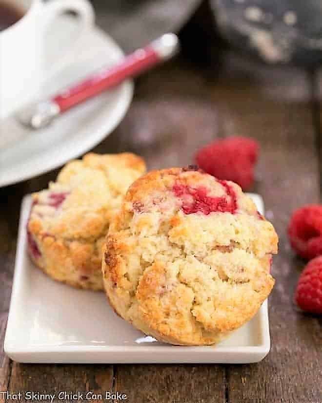 Raspberry Cream Scones - terrific, tender scones studded with fresh raspberries Raspberry Cream Scones on a square white plate.