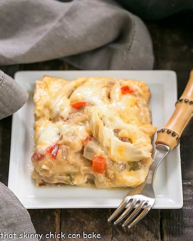 King Ranch Casserole from Scratch - the classic Tex-Mex casserole without canned soup! Hearty, comforting and delicious! King Ranch Casserole from Scratch on a white plate with a bamboo handled fork.