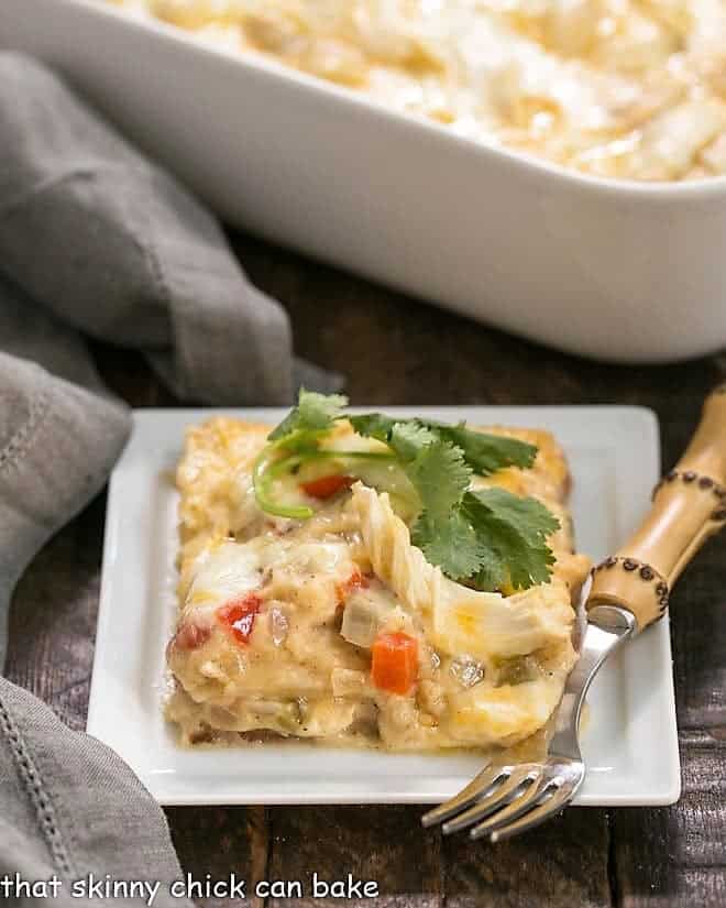 King Ranch Casserole from Scratch - the classic Tex-Mex casserole without canned soup! Hearty, comforting and delicious! King Ranch Casserole from Scratch on a white plate with a sprig of cilantro.