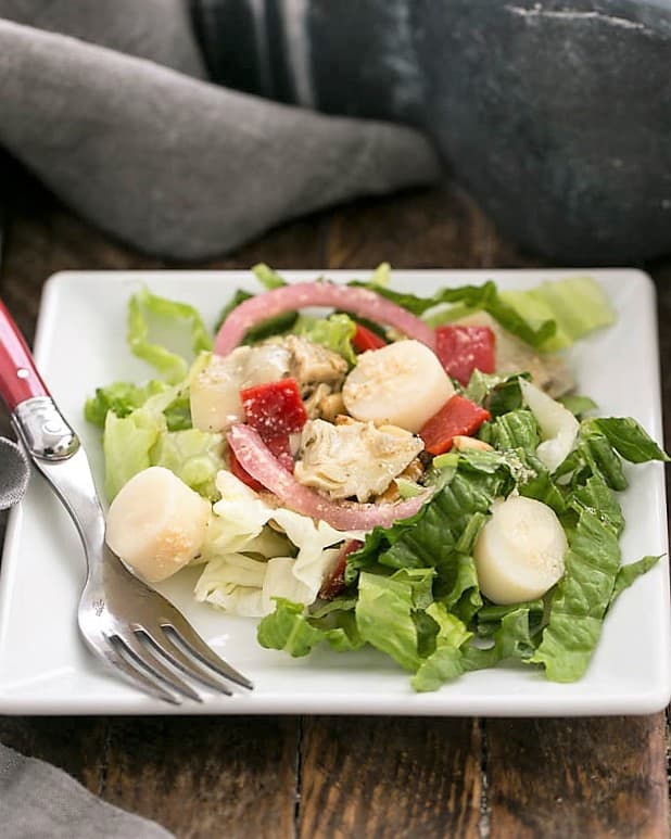 Italian Chopped Salad on a square plate with a fork.