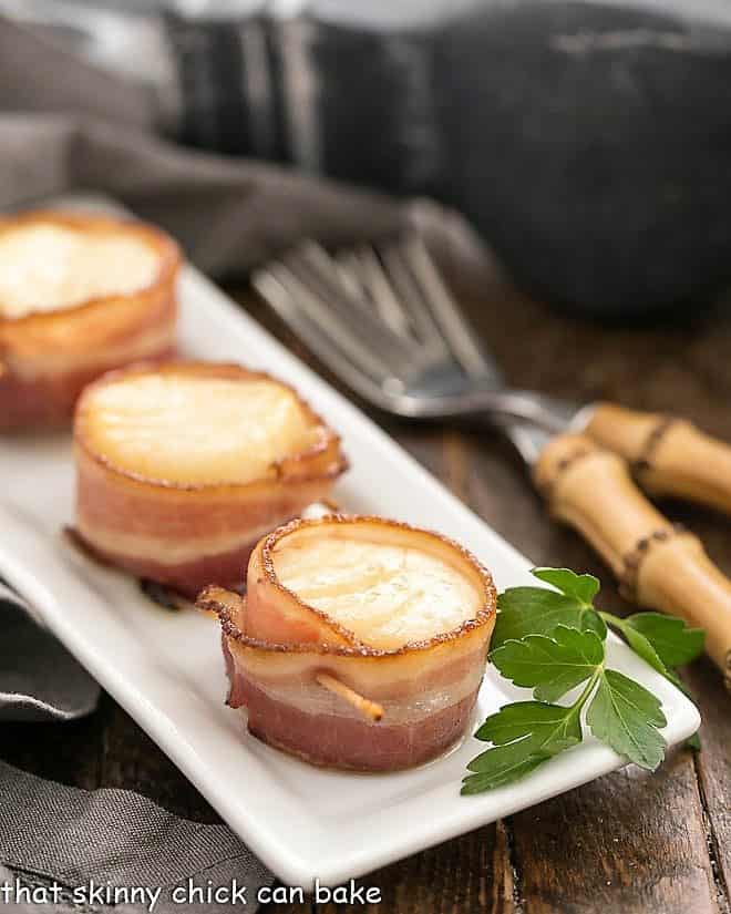 Bacon Wrapped Maple Scallops on a white platter