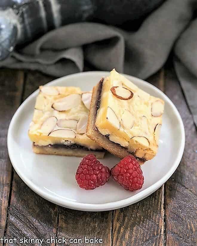  Raspberry Filled White Chocolate Bar on a round white plate with 2 raspberries.