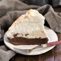 Slice of brownie baked Alaska on a white dessert plate