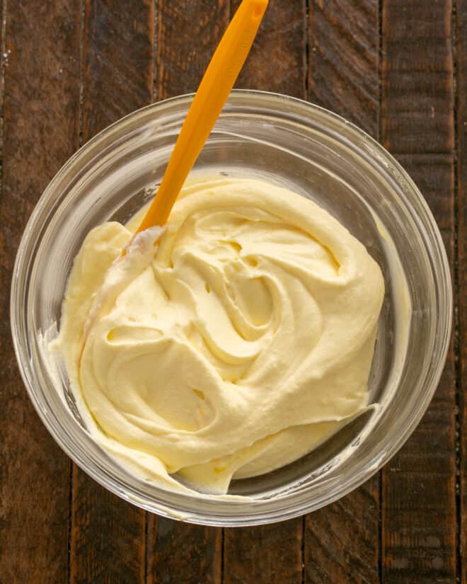 Mixing custard into whipped cream.