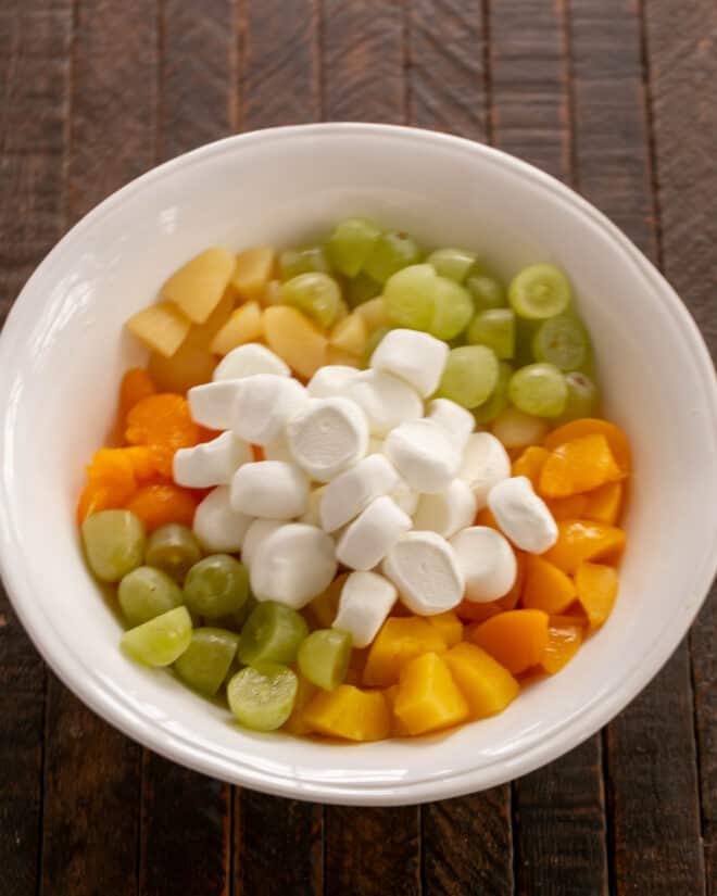 Fruit and marshmallows in a serving bowl.