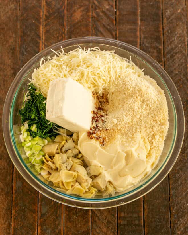 Spinach artichoke dip ingredients in a mixing bowl.