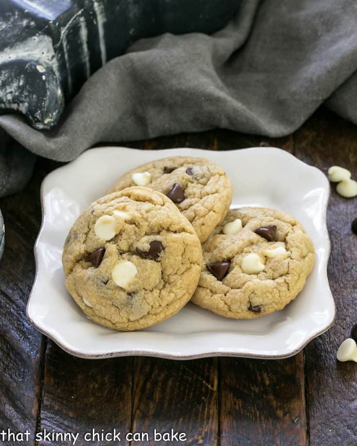 3 chocolate chip cookies with pudding on a square white plate