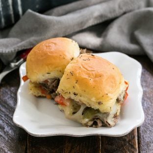 Two slider sandwiches on a small white ceramic plate