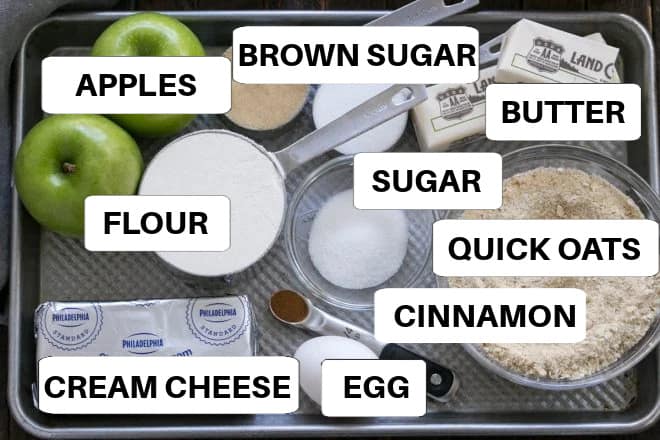 Caramel Apple Cheesecake Bars ingredients on a sheet pan with labels.