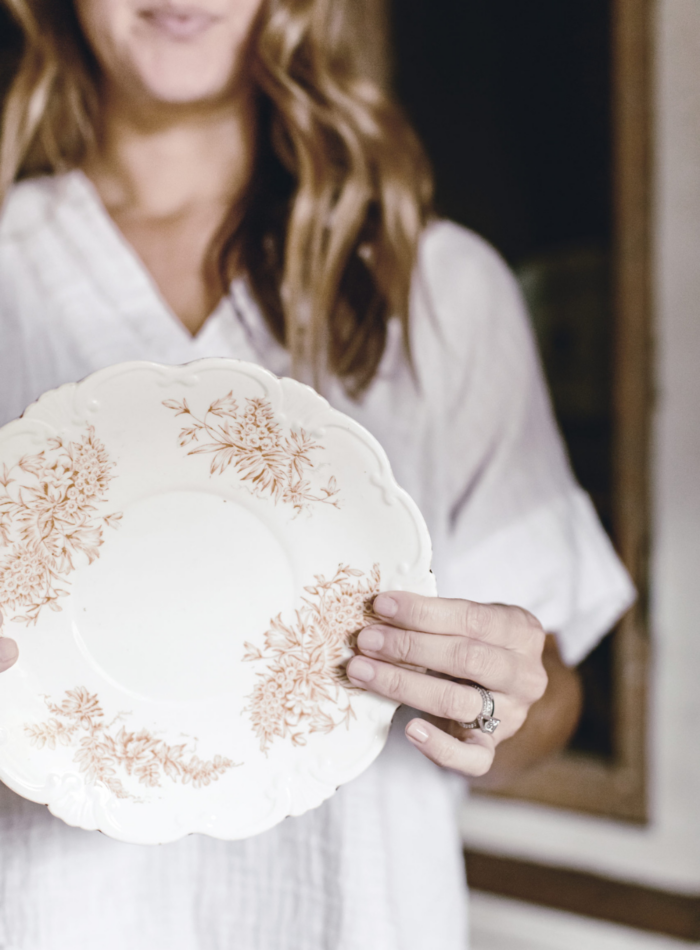 woman holding vintage Transferware plate