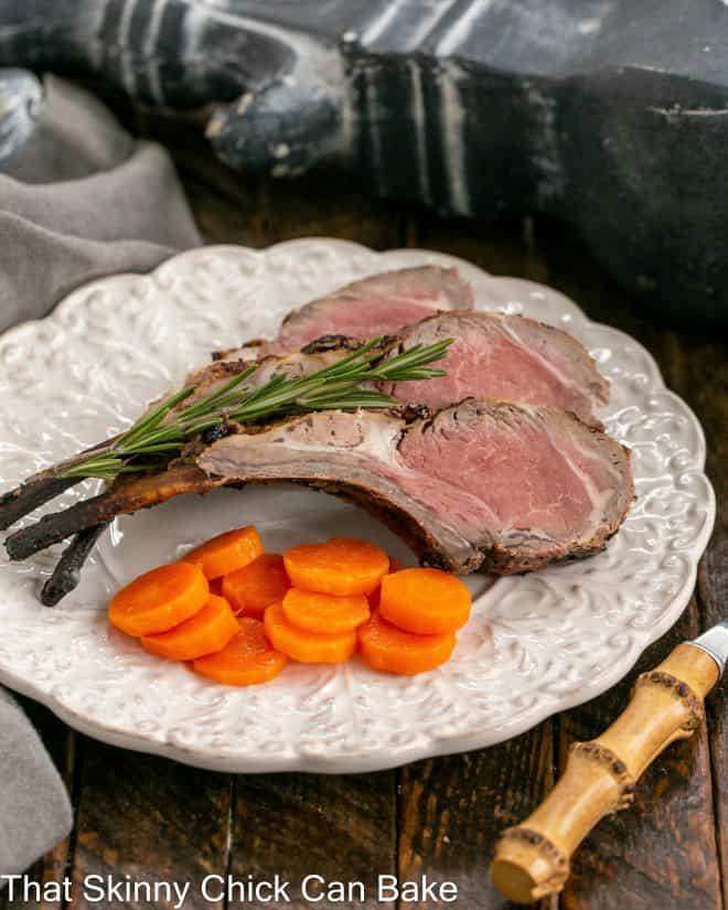 Marinated Grilled Lamb chops on a dinner plate with carrot coins.