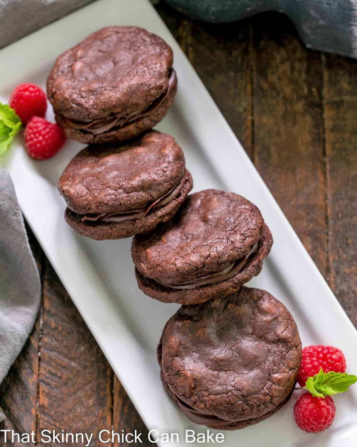 A white tray lined with chocolate sandwich cookies.