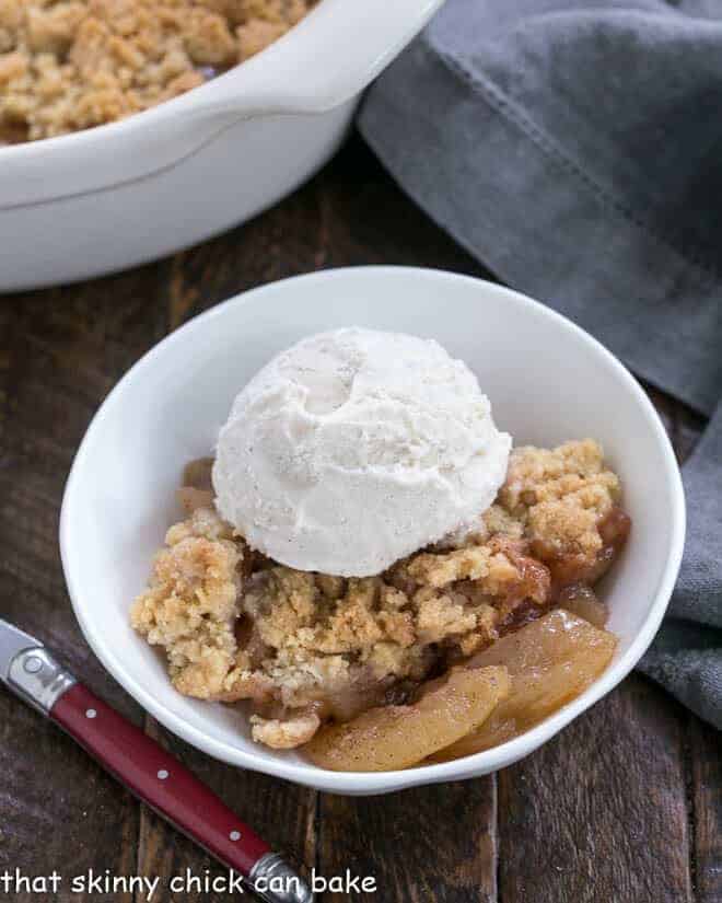 Apple crisp with a scoop of ice cream.