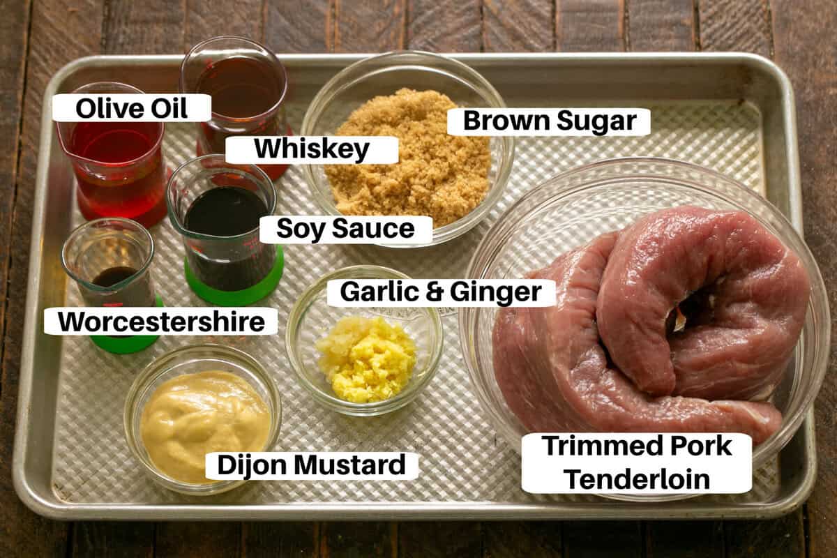 Whiskey Marinated Pork Tenderloin Ingredients with labels on a metal sheetpan.