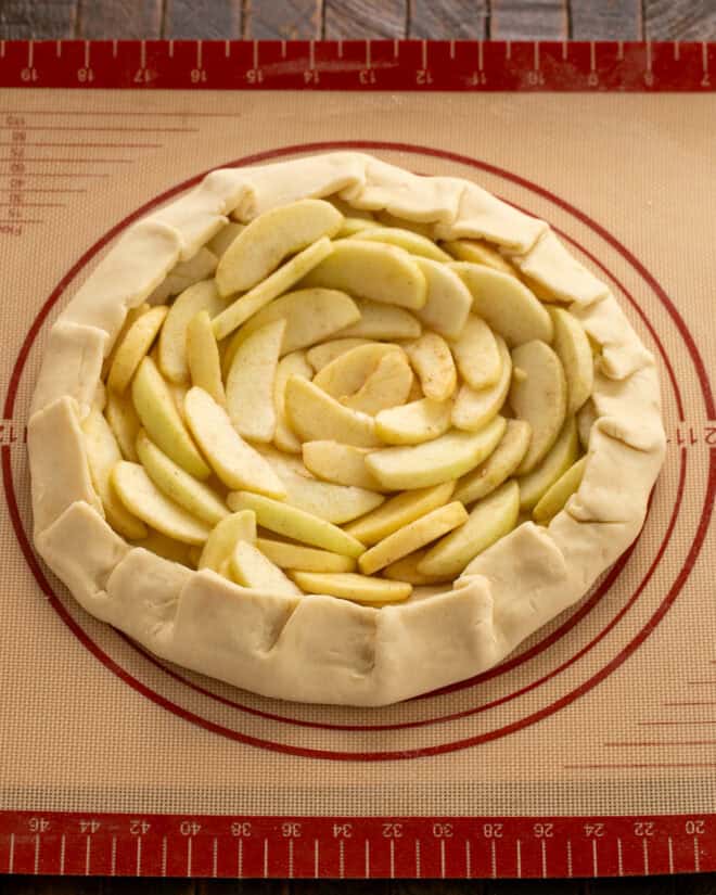 Unbaked apple galette on a sheetpan.