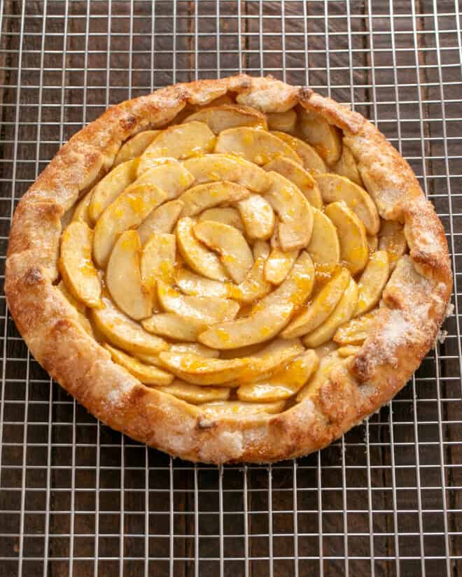 Baked apple galette cooling on a rack.